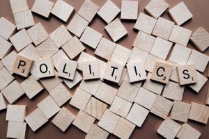 Board pieces spelling politics to represent the political voice acting article